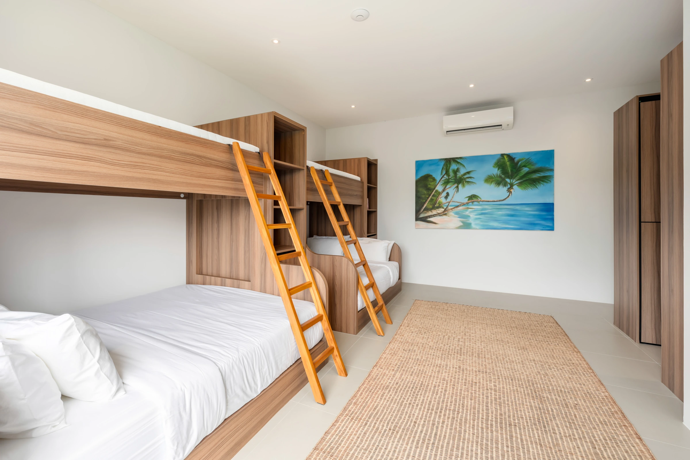 Wooden bunk beds and artwork in the room for six